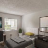 a bedroom with beds and a desk