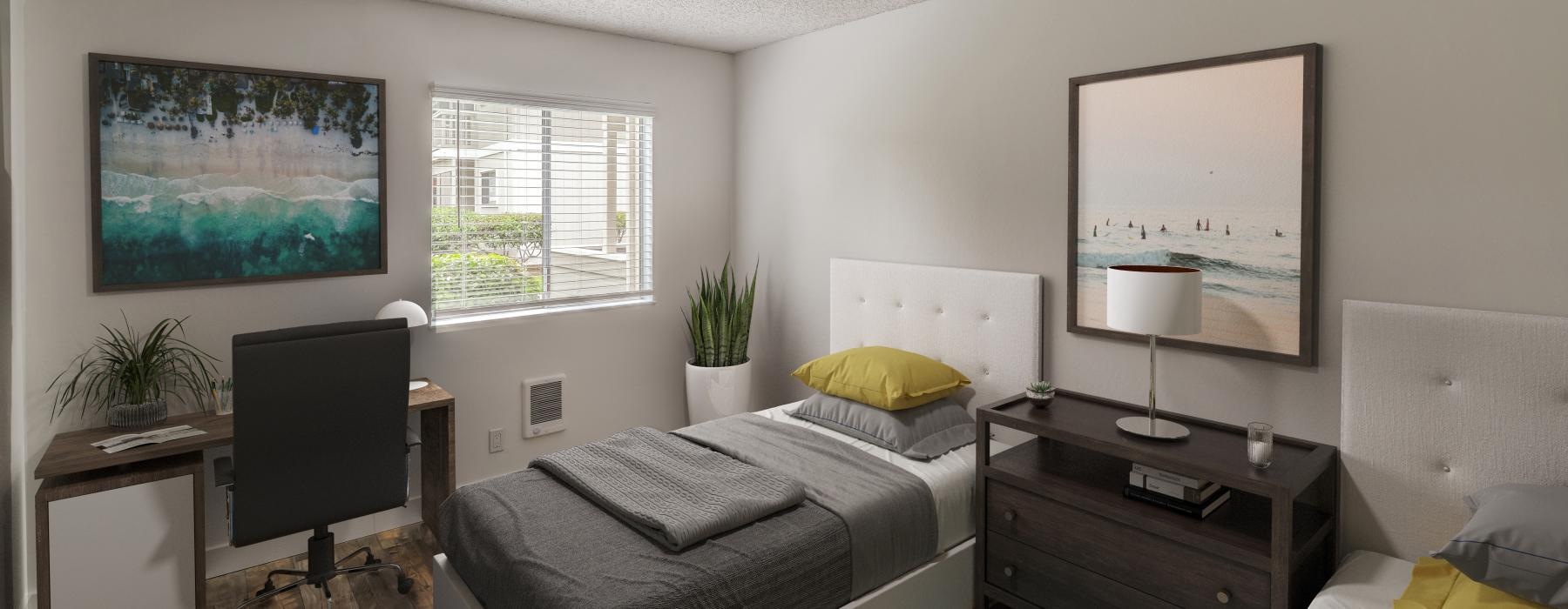 a bedroom with beds and a desk