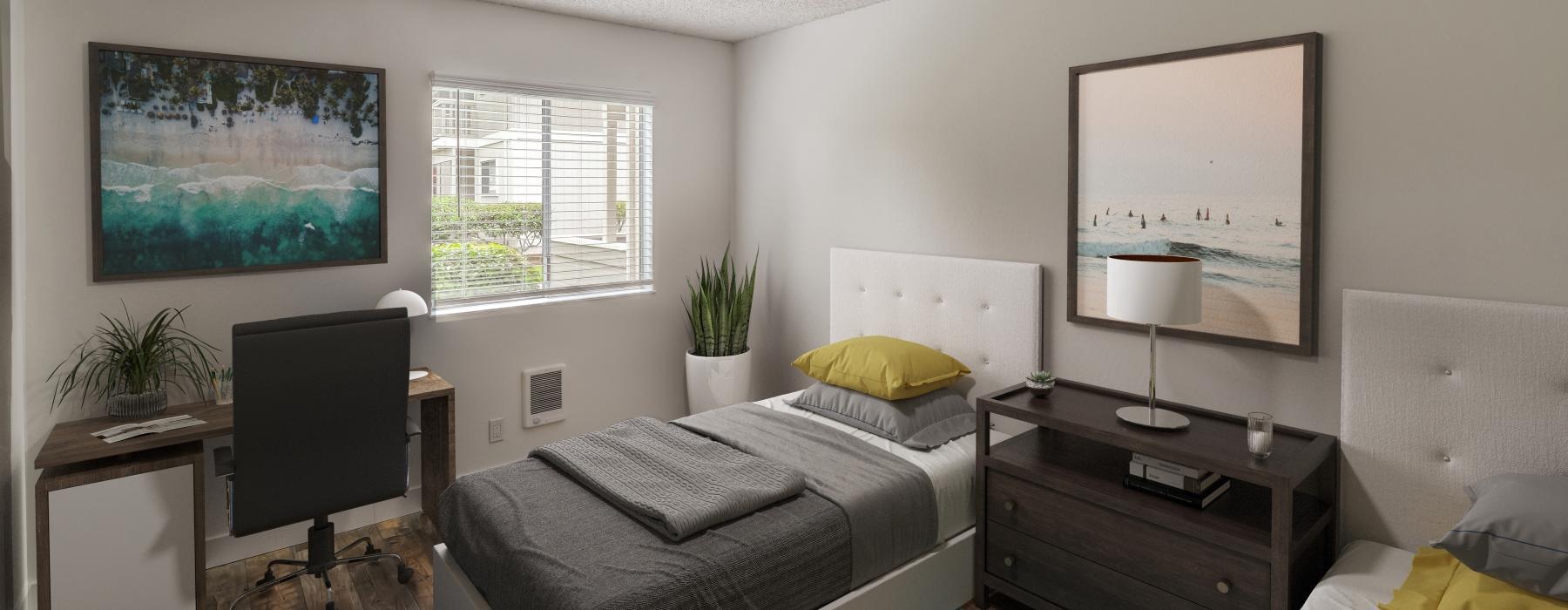 a bedroom with beds and a desk