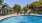 a swimming pool with a building in the background