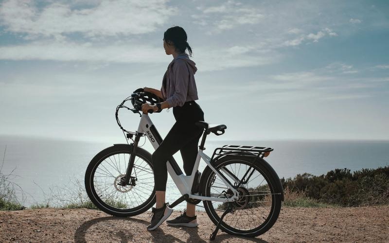 A beautiful community at the heart of all your passions a woman standing next to a bicycle