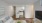 a living room with white walls and a tv